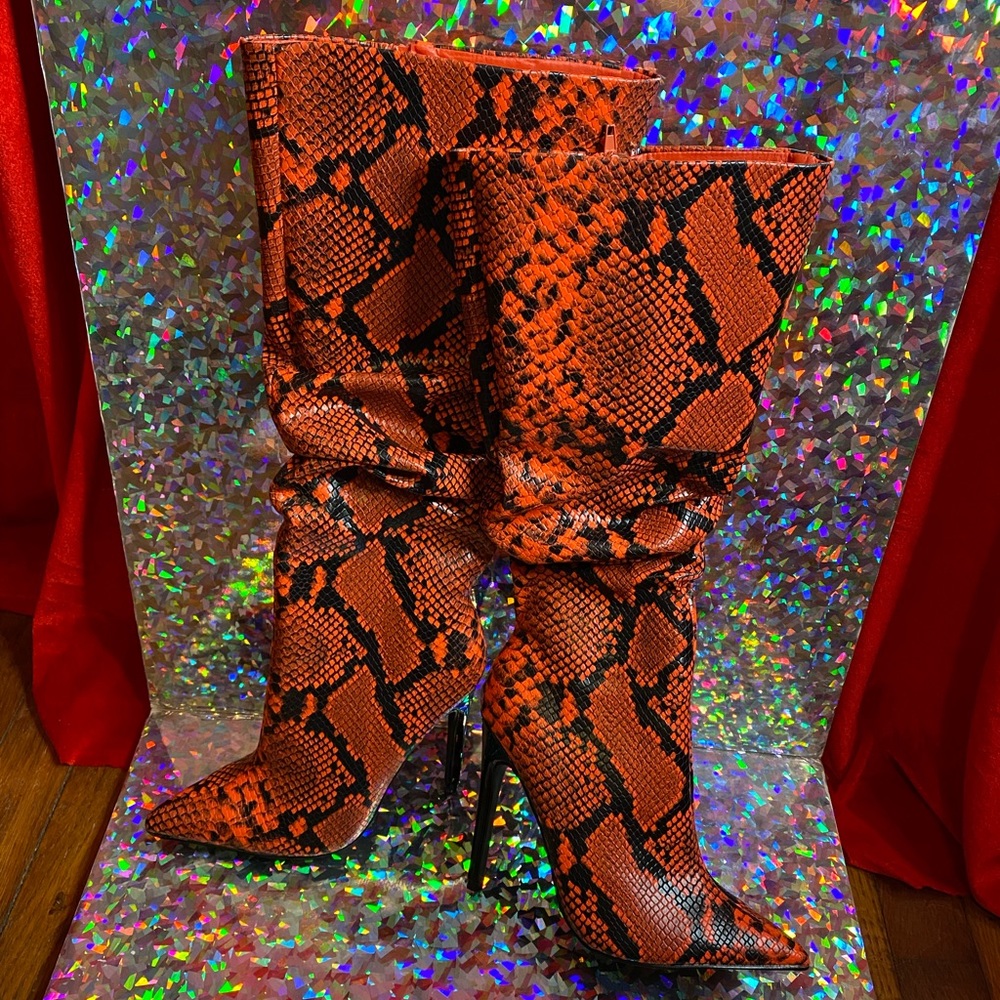 Orange snakeskin knee high boots